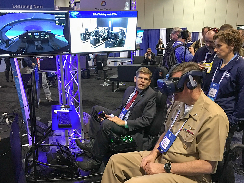 Cozad receives a demonstration from Joyner Livingston of Science Applications International Corporation of a virtual-reality flight simulator during the Interservice/Industry Training, Simulation, and Education Conference. I/ITSEC promotes cooperation among the armed services, industry, academia and other national and international organizations in pursuit of improved training and education programs, identification of common training issues, and development of multiservice programs.